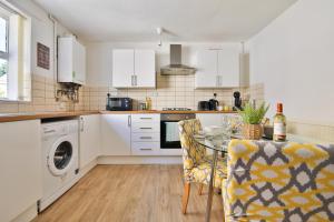 a kitchen with a table and a dining room at StayRight 2 Bed Central Flat- 10 mins walk to Castle & Centre in Cardiff