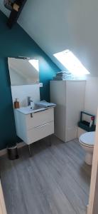 a bathroom with a sink and a toilet at Centre ville à 2 pas de la plage in Pornichet +2 photos