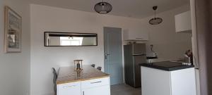 a kitchen with a counter top and a refrigerator at Centre ville à 2 pas de la plage in Pornichet