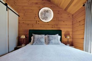 a bedroom with a bed with a moon on the wall at Lake View Cozy Cabin Hocking Hills with Pond and Hot Tub in Rockbridge