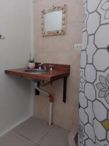 a bathroom with a sink and a mirror on the wall at El séptimo día, lugar de descanso in Funes