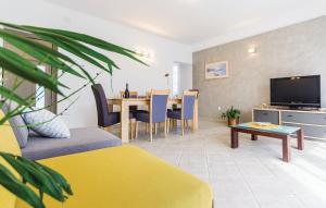 ein Wohnzimmer mit einem Sofa und einem Tisch mit einem TV in der Unterkunft Apartment Olive Garden Medulin I in Medulin