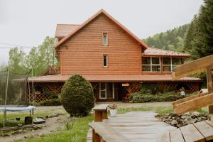 ein großes Holzhaus mit einem Weg davor in der Unterkunft Pensjonat Antoś in Baligród