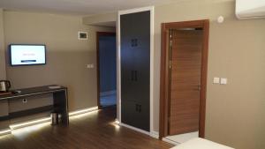 a room with a door and a television in a room at Bloom Suite Hotel in Keşan