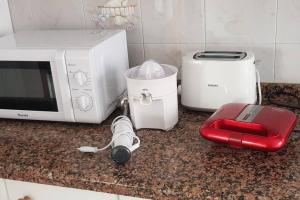 a kitchen counter with a microwave and a toaster at Piso vistas al mar 2. Playa Aguete. Rías Baixas in Marín +11 photos