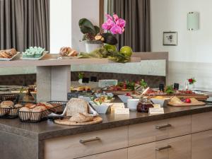 a buffet with different types of bread and other foods at Hotel B&B Martha in Brunico