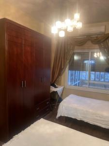 a bedroom with a large wooden cabinet and a bed at Welcome home in Bethlehem