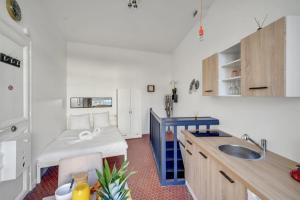 a kitchen with a sink and a bed in a room at Loft in heart of Paris Moulin Rouge in Paris