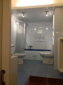 a bathroom with a sink and a toilet and a shower at Santa Lucia 4 in Florence