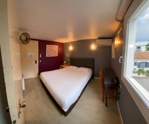 Ένα ή περισσότερα κρεβάτια σε δωμάτιο στο Contact Hotel LE SUD Montpellier Aéroport Parc Expo Arena