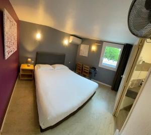 Ένα ή περισσότερα κρεβάτια σε δωμάτιο στο Contact Hotel LE SUD Montpellier Aéroport Parc Expo Arena