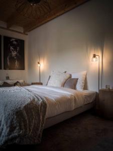 a bedroom with a large bed with two lamps at Venez Chez Vous - La Grange du Lac - Vue montagne in Saint-Jorioz