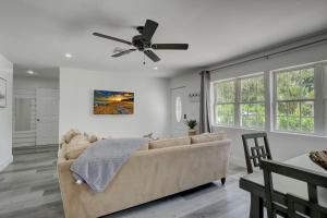 a living room with a couch and a ceiling fan at Walk to Downtown Bonita Springs From Our Home in Bonita Springs