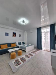 a living room with a couch and a table at kato's apartment in Tbilisi City