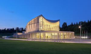 a large building is lit up at night at Apartament Nowe Miasto - przy Deptaku Chrobrego in Gorzów Wielkopolski