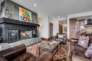 a living room with couches and a fireplace at Luxury 3 BR Residence-Ski-in out in Bachelor Gulch condo in Avon