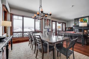 a dining room with a table and chairs at Luxury 3 BR Residence-Ski-in out in Bachelor Gulch condo in Avon