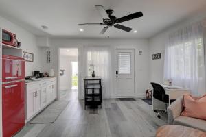 a kitchen with a ceiling fan and a red refrigerator at Private Studio Tucked Away on a Private Compound in Bonita Springs