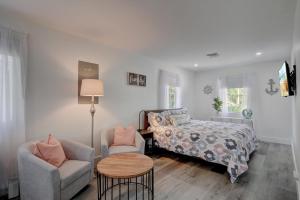 a bedroom with a bed and a chair and a table at Private Studio Tucked Away on a Private Compound in Bonita Springs +17 photos