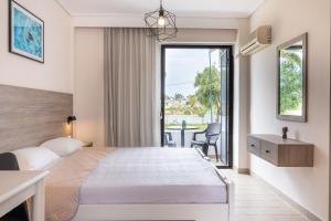 a hotel room with a bed and a balcony at Anthia Apartments in Marmari