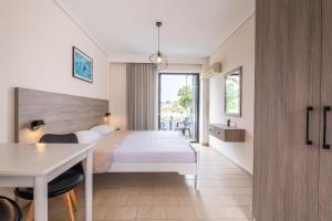 a hotel room with a bed and a table at Anthia Apartments in Marmari