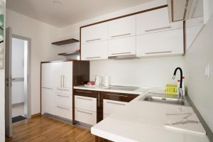 a kitchen with white cabinets and a sink at Kašmir in Bugojno