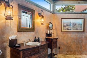 a bathroom with a sink and a mirror at Adobe Village Inn in Sedona