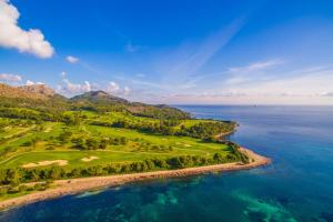 an aerial view of a golf course next to the ocean at Ideal Property Mallorca - Es Romani Alcudia in Alcudia