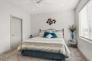 a bedroom with a large bed with blue pillows at Coco Oasis #25 townhouse in Santa Clara