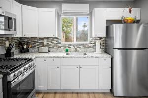 a kitchen with white cabinets and a stainless steel refrigerator at Chelsea Place in Phoenix