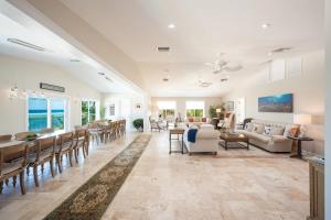 a living room with a table and chairs and a couch at Fischers Reef by Grand Cayman Villas & Condos in Driftwood Village