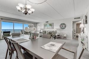 a dining room and living room with a table and chairs at G3 Amelia South condo in Fernandina Beach