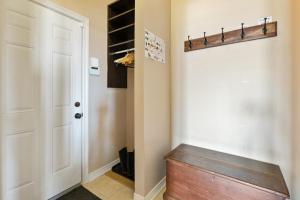 a closet with a wooden bench next to a door at Luxury Chalet-Walk to Beach/Village w Mtn View in Blue Mountains