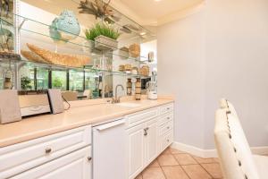 a kitchen with a sink and a mirror at Phoenix on the Bay 1122 condo in Orange Beach