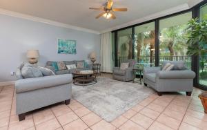 a living room with a couch and chairs and a table at Phoenix on the Bay 1122 condo in Orange Beach