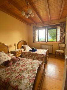 a bedroom with two beds and a window at CASA LUISA Biedes, Piloña in Infiesto
