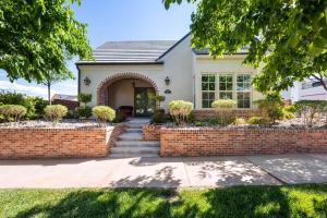 a house with a brick fence and a brick walkway at The Ella home in Hurricane