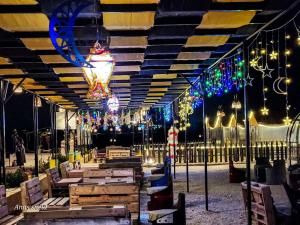 a patio with a bunch of lights and lights at Wadi Al-Wala View Camp in Madaba +100 photos