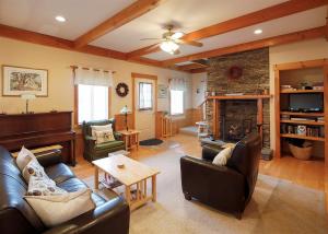 a living room with leather furniture and a fireplace at COZY COVE COTTAGE LIMIT 6 cottage in Standish