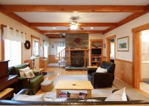 a living room with couches and a fireplace at COZY COVE COTTAGE LIMIT 6 cottage in Standish