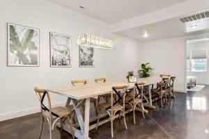 a dining room with a large table and chairs at Highlander townhouse in Hurricane