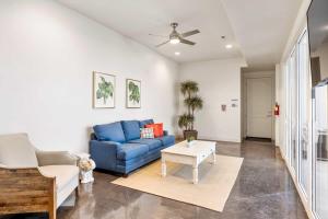 a living room with a blue couch and a table at Highlander townhouse in Hurricane