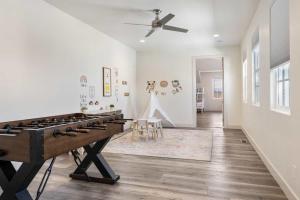 a living room with a pool table and a ceiling fan at Highlander townhouse in Hurricane