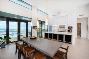 a kitchen and dining room with a table and chairs at Wind Upon The Waves by Grand Cayman Villas & Condos in North Side