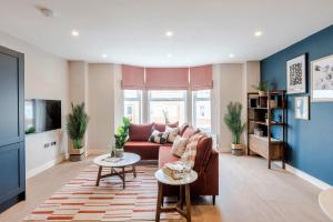 a living room with a couch and a table at Shepherds Bush - Your Apartment in London