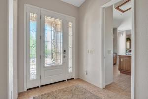 an empty hallway with a door and windows at Prescott Luxury Home near Golf Course and Airport home in Prescott Valley