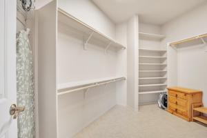 a walk in closet with white walls and shelves at Prescott Luxury Home near Golf Course and Airport home in Prescott Valley +24 photos