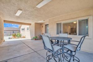 a patio with a table and chairs on a porch at Prescott Luxury Home near Golf Course and Airport home in Prescott Valley