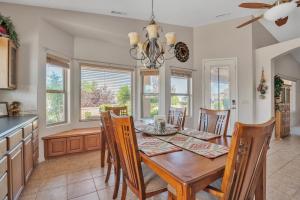 a kitchen and dining room with a wooden table and chairs at Prescott Luxury Home near Golf Course and Airport home in Prescott Valley