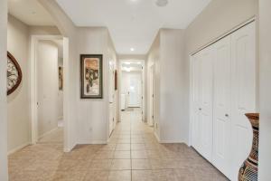 a hallway of a home with white walls and a tile floor at Prescott Luxury Home near Golf Course and Airport home in Prescott Valley